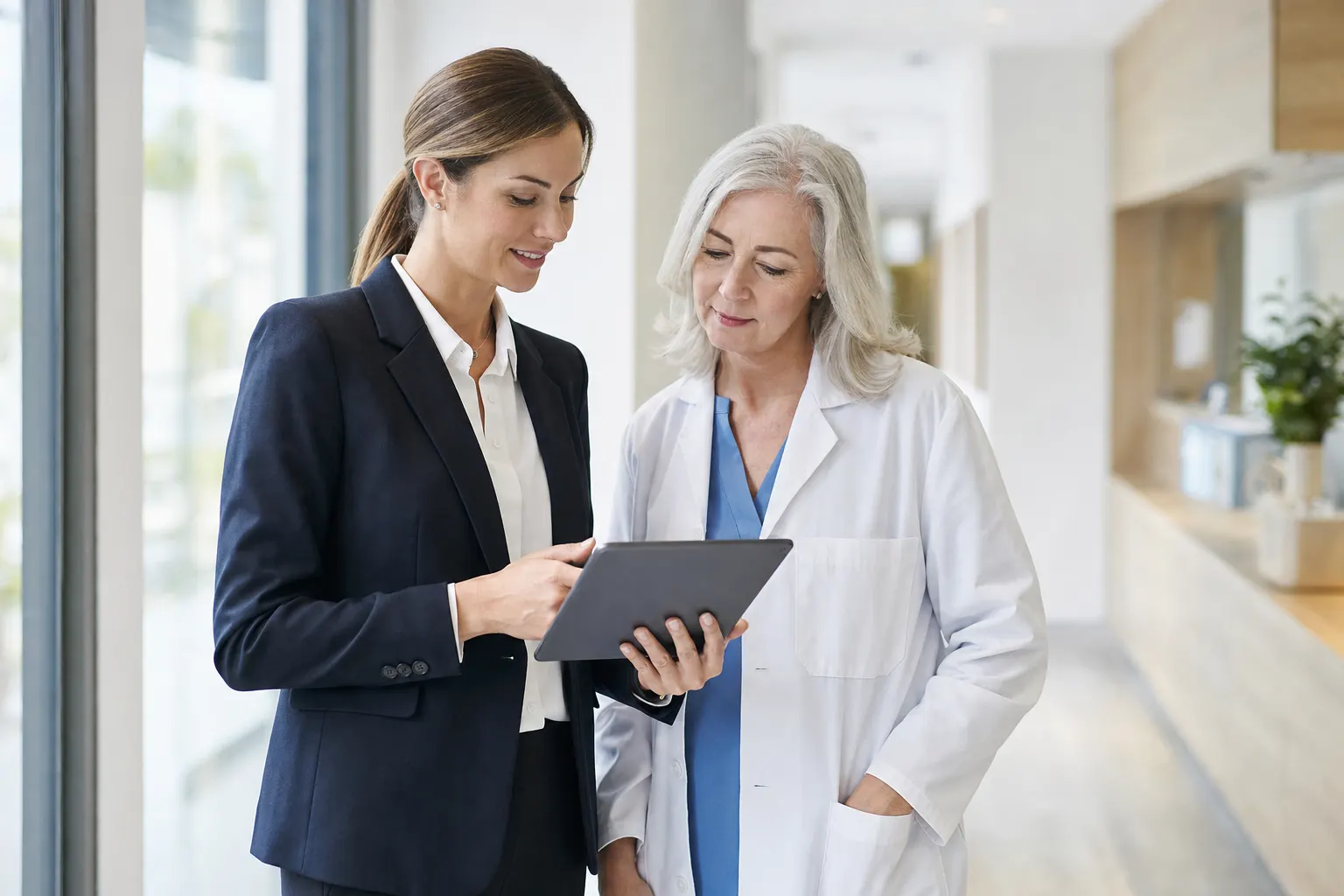 A billing specialist reviewing claims with a provider